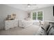 This bedroom has wood-look accent walls, a day bed, and a couch area to relax at 2535 Hampton Trl, Cumming, GA 30041