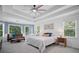 Light-filled bedroom with tray ceiling, shiplap accent wall and large windows at 2535 Hampton Trl, Cumming, GA 30041
