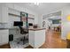Bright home office with built-in cabinets, desk, and open layout, with view into dining room at 2535 Hampton Trl, Cumming, GA 30041