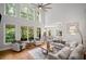 Sun-filled living room features tall windows, comfortable seating, and hardwood floors at 2535 Hampton Trl, Cumming, GA 30041