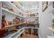 Organized pantry with white shelves, wood countertop and laminate flooring at 2535 Hampton Trl, Cumming, GA 30041