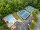 Aerial view of community pool and tennis courts surrounded by lush greenery at 3078 Milford Chase Sw, Marietta, GA 30008