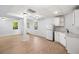 Partially finished basement with wood-look flooring, windows, and a kitchenette space at 3078 Milford Chase Sw, Marietta, GA 30008
