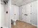 Bathroom featuring a toilet, stall shower with black hardware, and wood-look floors at 3078 Milford Chase Sw, Marietta, GA 30008