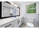Modern bathroom features a large mirror, stylish vanity and toilet at 3078 Milford Chase Sw, Marietta, GA 30008