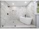 Modern bathroom with walk-in shower, free-standing tub and marble style tile at 3078 Milford Chase Sw, Marietta, GA 30008