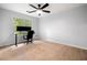Minimalist bedroom with hardwood floors, natural light, and a ceiling fan at 3078 Milford Chase Sw, Marietta, GA 30008