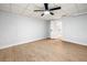Bedroom with wood-look flooring, ceiling fan, and white walls with a closet at 3078 Milford Chase Sw, Marietta, GA 30008