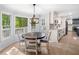 Bright dining area featuring a round table, stylish light fixture, and seamless flow into the updated kitchen at 3078 Milford Chase Sw, Marietta, GA 30008