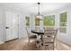 Inviting dining area with a charming light fixture and large windows offering scenic views of the outdoors at 3078 Milford Chase Sw, Marietta, GA 30008