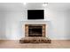 Cozy room featuring a brick fireplace with a white mantel and wood-look floors at 3078 Milford Chase Sw, Marietta, GA 30008