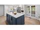 Island with quartz countertops and stainless appliances, enhanced by natural light from the French doors at 3078 Milford Chase Sw, Marietta, GA 30008