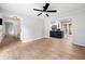 Bright living room features a ceiling fan and an open floor plan to the kitchen at 3078 Milford Chase Sw, Marietta, GA 30008