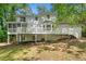 Rear exterior view of two-story home with deck and screened porch at 3078 Milford Chase Sw, Marietta, GA 30008