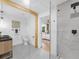 Stylish bathroom boasting a glass shower, wooden beam, and a view into the primary bedroom at 3779 Elkridge Dr, Decatur, GA 30032