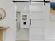 Modern bathroom featuring a sliding barn door, glass shower, and contemporary design at 3779 Elkridge Dr, Decatur, GA 30032