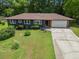 A house featuring well-maintained yard space with a wide driveway leading to an attached garage at 3779 Elkridge Dr, Decatur, GA 30032