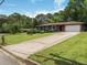 Charming one-story home with a long driveway, well-manicured lawn, and a welcoming facade at 3779 Elkridge Dr, Decatur, GA 30032