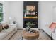 Cozy living room with an electric fireplace, neutral tones, comfortable seating, and a decorative rug at 3779 Elkridge Dr, Decatur, GA 30032