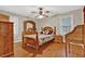 Traditional-style bedroom with hardwood floors, ceiling fan, and light neutral paint at 200 Dogwood Dr, Canton, GA 30114
