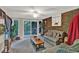 Relaxing sun room features exposed brick wall, neutral carpet, ceiling fan and outdoor access at 200 Dogwood Dr, Canton, GA 30114