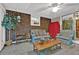 The sun room is furnished with comfortable seating, exposed brick, and lots of natural light at 200 Dogwood Dr, Canton, GA 30114