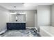 Modern bathroom featuring double vanity, shower, and soaking tub with luxury-look waterproof flooring at 2430 Redbud Meadow Ln, Douglasville, GA 30135