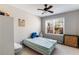 Bedroom features neutral paint, a ceiling fan, carpet, and a window providing natural light at 2430 Redbud Meadow Ln, Douglasville, GA 30135