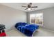 A simple bedroom with neutral colored walls and carpet is brightly lit by a window at 2430 Redbud Meadow Ln, Douglasville, GA 30135