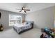 Cozy bedroom with a window, ceiling fan, and plenty of space for relaxing and sleeping at 2430 Redbud Meadow Ln, Douglasville, GA 30135