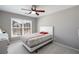 A well-lit bedroom featuring a bed, window, and a ceiling fan with hardwood floors at 2430 Redbud Meadow Ln, Douglasville, GA 30135
