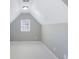 This bonus room has neutral decor, carpeted floors, and a natural light from the double hung window at 2430 Redbud Meadow Ln, Douglasville, GA 30135