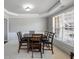 Elegant dining room featuring wainscoting, tray ceiling, and a large window, ideal for formal dinners at 2430 Redbud Meadow Ln, Douglasville, GA 30135