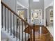 Inviting foyer with gleaming wood floors and staircase leading to the upper level at 2430 Redbud Meadow Ln, Douglasville, GA 30135