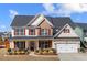 Charming two-story home featuring manicured landscaping and a welcoming front porch, perfect for suburban living at 2430 Redbud Meadow Ln, Douglasville, GA 30135