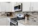 Close up of the modern kitchen showcasing stainless steel appliances and granite countertops at 2430 Redbud Meadow Ln, Douglasville, GA 30135
