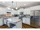 Stylish kitchen featuring stainless steel appliances, white cabinets, and center island at 2430 Redbud Meadow Ln, Douglasville, GA 30135