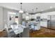 Modern kitchen with stainless steel appliances, island, white cabinets, and eat-in area at 2430 Redbud Meadow Ln, Douglasville, GA 30135