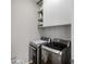 The laundry room has newer model washer and dryer, shelves for storage, and neutral paint at 2430 Redbud Meadow Ln, Douglasville, GA 30135
