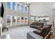 Bright living room boasts soaring windows, neutral decor, and an open floorplan to the kitchen at 2430 Redbud Meadow Ln, Douglasville, GA 30135