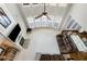 Bright living room featuring a high ceiling, large windows, fireplace, and comfortable seating at 2430 Redbud Meadow Ln, Douglasville, GA 30135