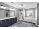 Modern main bathroom features dual sinks, a soaking tub, and separate shower with unique epoxy flooring at 2430 Redbud Meadow Ln, Douglasville, GA 30135