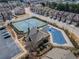 This aerial view shows the neighborhood pool, community tennis courts, and clubhouse with ample parking at 3318 Sardis Bend Dr, Buford, GA 30519