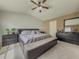Comfortable primary bedroom with a neutral color palette, soft carpeting and a modern ceiling fan at 3318 Sardis Bend Dr, Buford, GA 30519