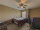 Cozy bedroom with a ceiling fan, a window for natural light, and neutral wall-to-wall carpeting at 3318 Sardis Bend Dr, Buford, GA 30519