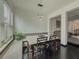 Bright dining area with a window seat, modern lighting, and dark wood floors open to the living spaces at 3318 Sardis Bend Dr, Buford, GA 30519