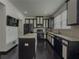 Modern kitchen featuring black appliances, granite countertops, and a central island at 3318 Sardis Bend Dr, Buford, GA 30519