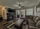 Spacious living room with a fireplace, modern ceiling fan, open layout, and stylish decor at 3318 Sardis Bend Dr, Buford, GA 30519