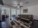 Open-concept living room featuring a large sectional sofa, dark wood floors, and plenty of natural light at 3318 Sardis Bend Dr, Buford, GA 30519