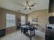 Home office space with large windows, vaulted ceiling, fan and black desk at 3318 Sardis Bend Dr, Buford, GA 30519